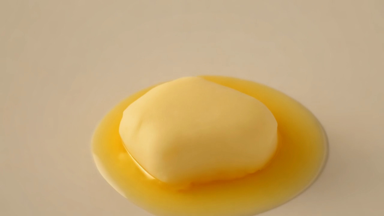 Generated butter softening and spreading as it melts